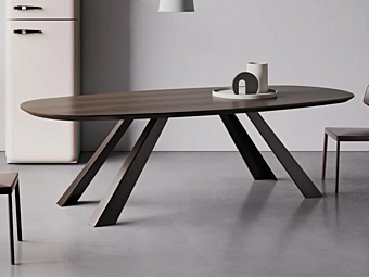 Oval wooden dining table Paul Martini Interiors